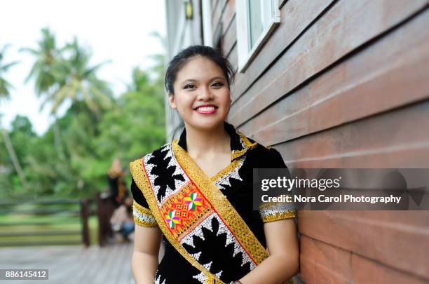 smiling malaysian young woman in dusun lotud traditional cloth sabah borneo native - malaysian culture stock-fotos und bilder