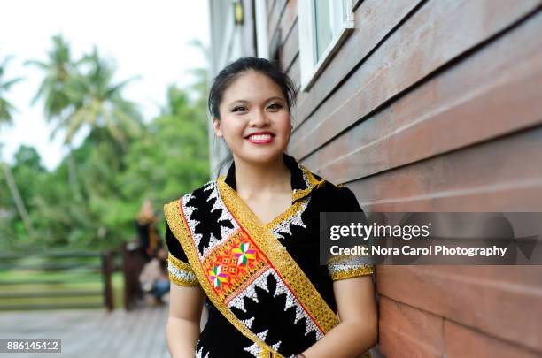 smiling malaysian young woman in dusun lotud traditional cloth sabah borneo native - malaysian culture 個照片及圖片檔