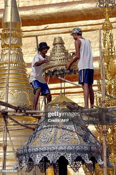 Photo taken May 1, 2009 shows workers as they fix an element during maintenance work at the Shwedagon Pagoda in Yangon. Myanmar is a predominantly...