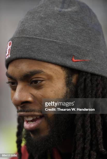 Seattle Seahawks and Stanford alumni Richard Sherman looks on prior to the start of the Pac-12 Football Championship Game between the USC Trojans and...