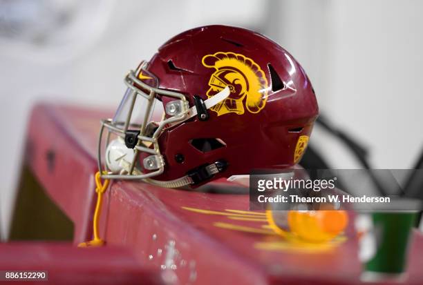 Detailed view of a helmet belonging to a USC Trojans player sitting on the bench during the Pac-12 Football Championship Game against the Stanford...