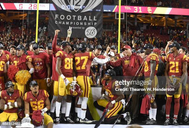 Head coach Clay Helton of the USC Trojans and his team celebrates after they beat the Stanford Cardinal 31-28 in the Pac-12 Football Championship...