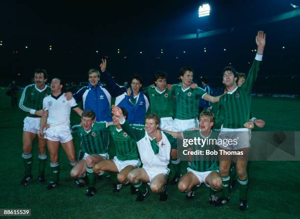 The Northern Ireland team celebrate after a 0-0 draw with England at Wembley Stadium had ensured their qualification for the 1986 World Cup Finals,...