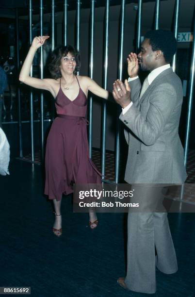 West Bromwich Albion winger Laurie Cunningham dancing with Helen Scott, a singer with the Three Degrees, at the Holy City Zoo nightclub in...