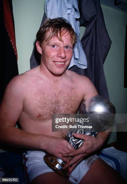 England Under-21 captain Sammy Lee proudly holding the UEFA Under-21 Championship trophy in the dressing room after England had beaten West Germany...