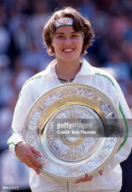 Martina Hingis of Switzerland holding the trophy after winning the ladies' singles final of the Wimbledon Lawn Tennis Championships held at the All...