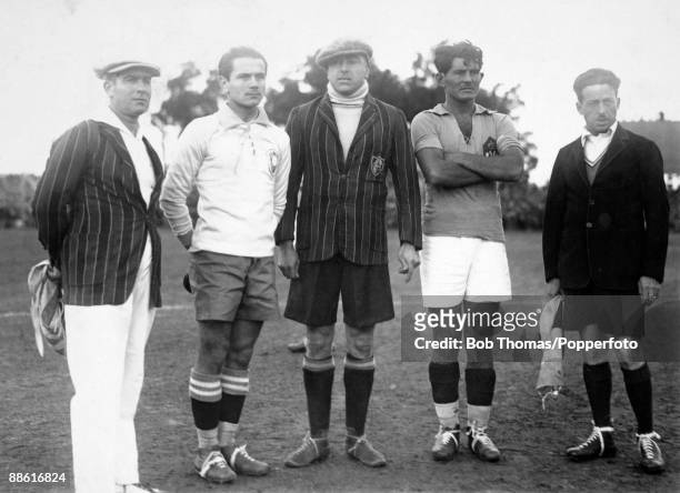 Referee Anibal Tejeda and linesmen Ricardo Vallarino and Mr Baldway line up with the captains of Brazil, Jao Coelho Neto and Milutin Ivkovic of...