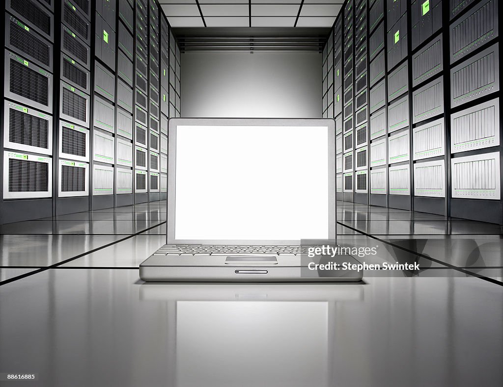 A laptop on the floor of a Network server room