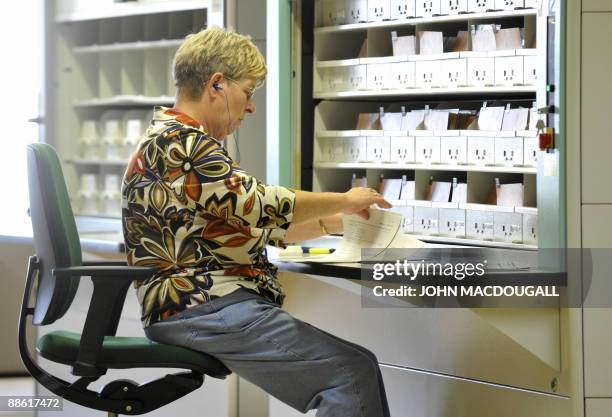 Worker checks data in a card catalog of the archives of the former East German secret police, known as the Stasi in Berlin on June 22, 2009. The...