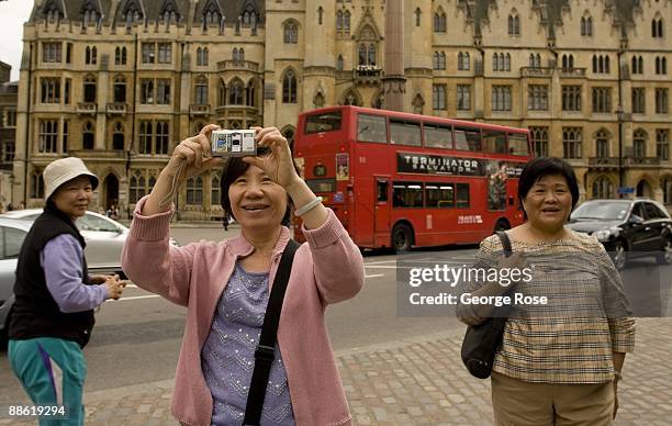 Tourist takes a picture on Victoria Road as seen in this 2009 London, United Kingdom, afternoon cityscape photo.