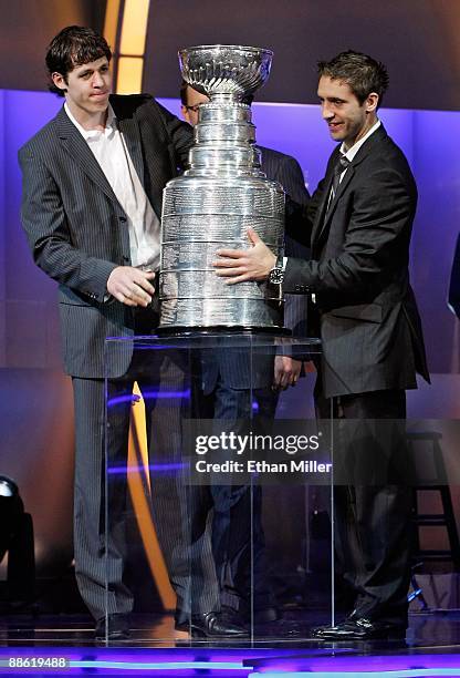 Evgeni Malkin and Max Talbot of the Pittsburgh Penguins place the Stanley Cup on the stage during the 2009 NHL Awards at The Pearl concert theater at...