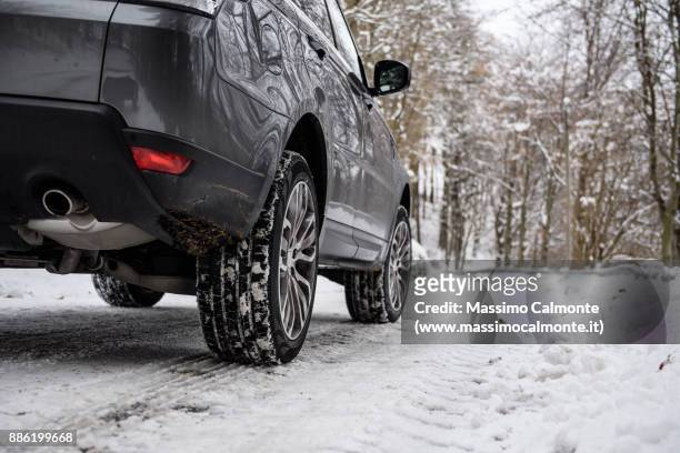close-up of winter car tires mounted on a sport utility vehicle - bilar i snö bildbanksfoton och bilder