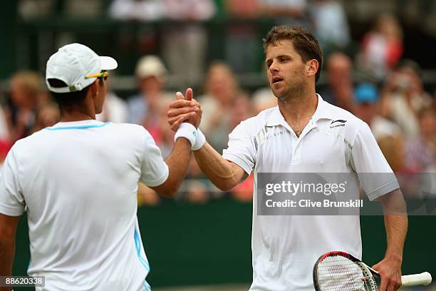 Jeff Coetzee of South Africa shakes hands with Jordan Kerr of Australia during the men's doubles first round match against David Ferrer of Spain and...