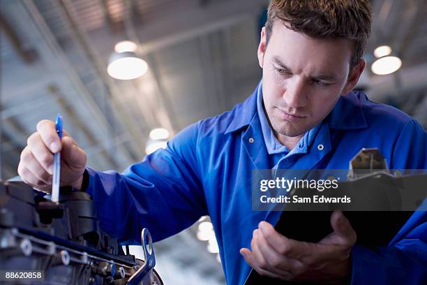 mechanic checking engine - car workshop stock pictures, royalty-free photos & images