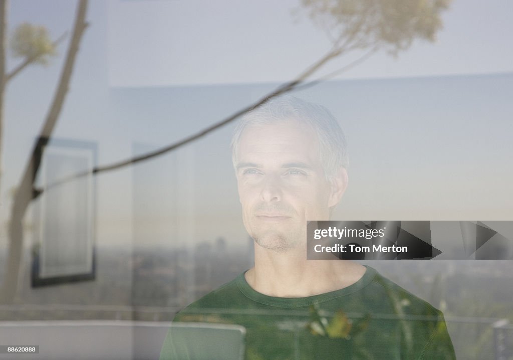 Man looking out living room window