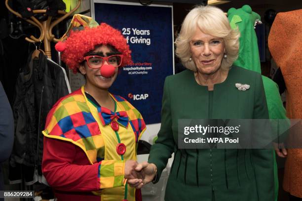 Camilla, Duchess of Cornwall, Patron, Medical Detection Dogs, meets staff and charity representatives during her visit to ICAP during the broker's...