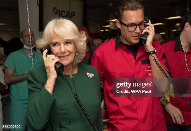 Camilla, Duchess of Cornwall, Patron, Medical Detection Dogs, on the phone during her visit to ICAP during the broker's annual ICAP charity day at...