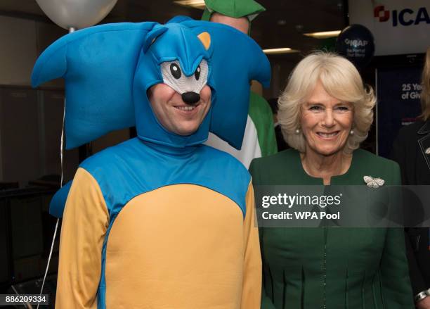 Camilla, Duchess of Cornwall, Patron, Medical Detection Dogs, meets staff and charity representatives during her visit to ICAP during the broker's...