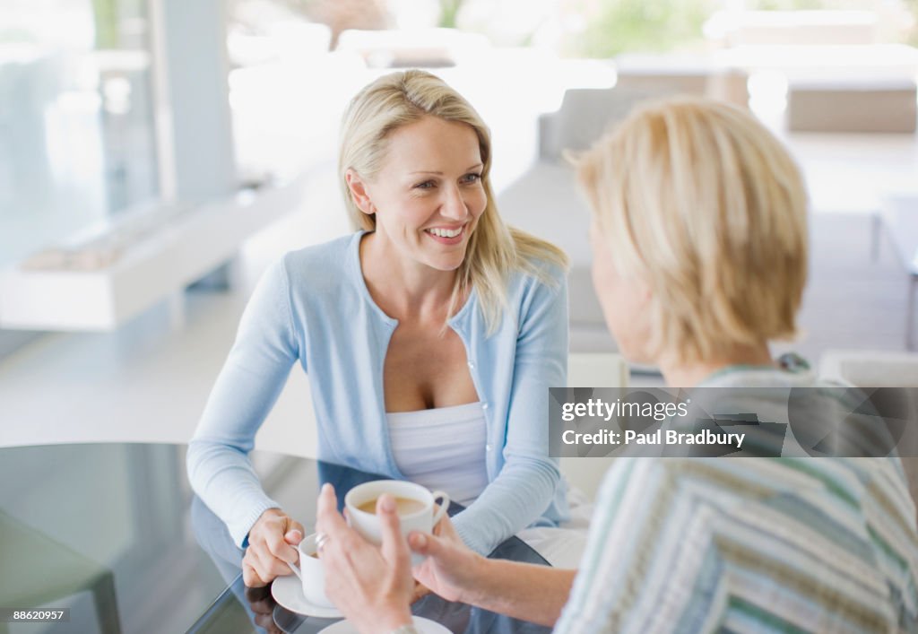 Friends talking and drinking coffee