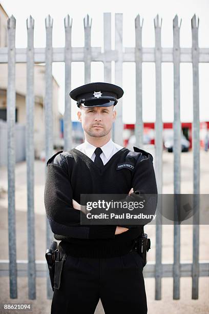 security guard standing in front of gate - police force uk stock pictures, royalty-free photos & images