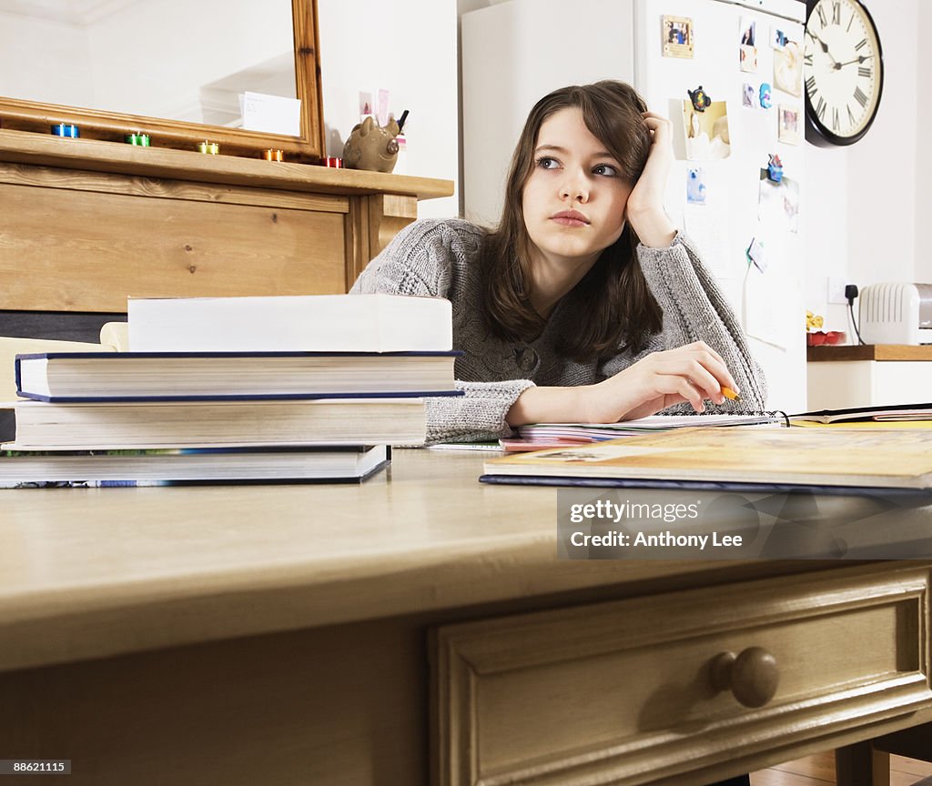 Girl doing homework in kitchen
