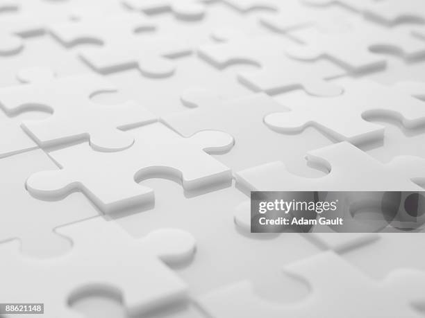 interlocking puzzle pieces - puzzel stockfoto's en -beelden