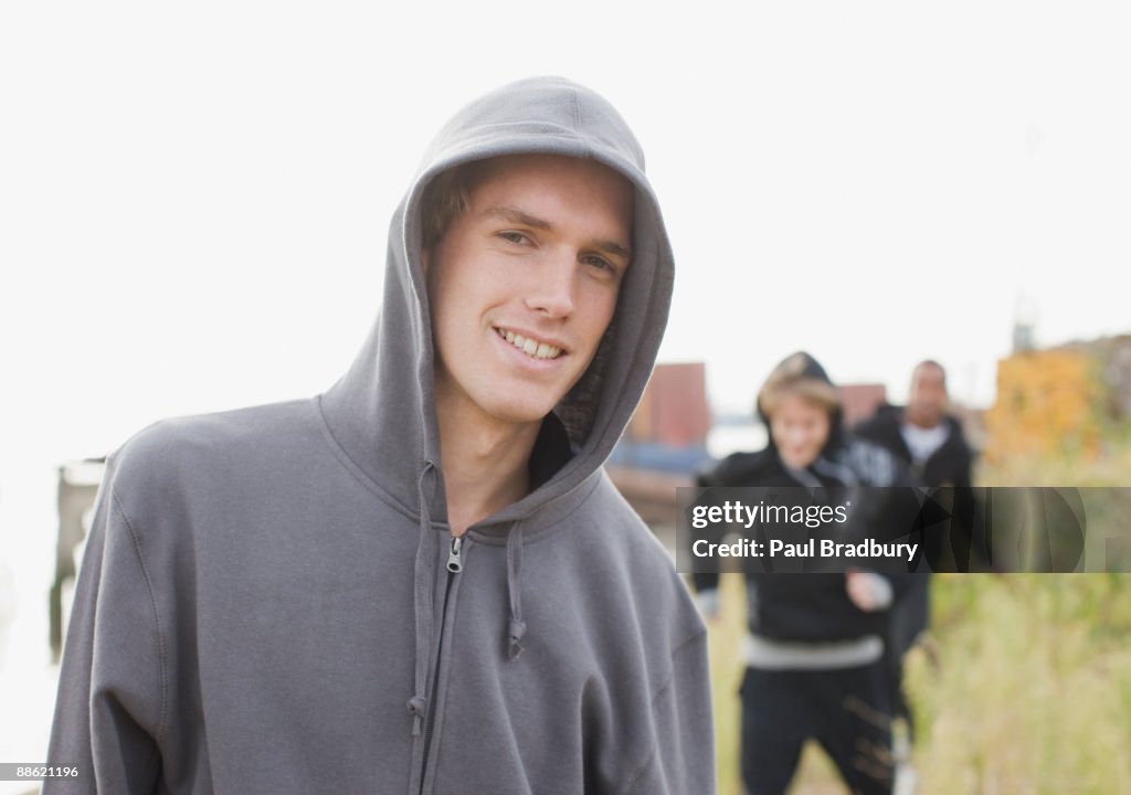 Three young men walking through urban field
