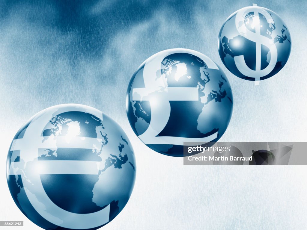 Globes with euro, pound and dollar symbols