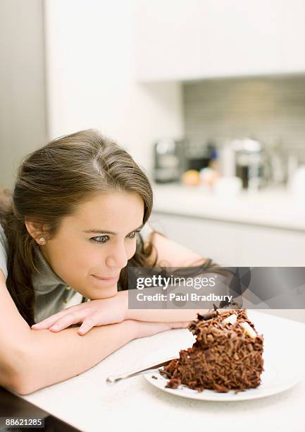 woman staring at chocolate cake - woman chocolate stock pictures, royalty-free photos & images