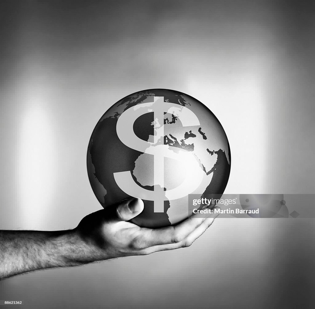 Man holding globe with dollar symbol