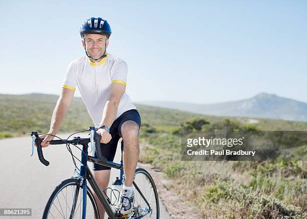 man in helmet sitting on bicycle - spandex stockfoto's en -beelden
