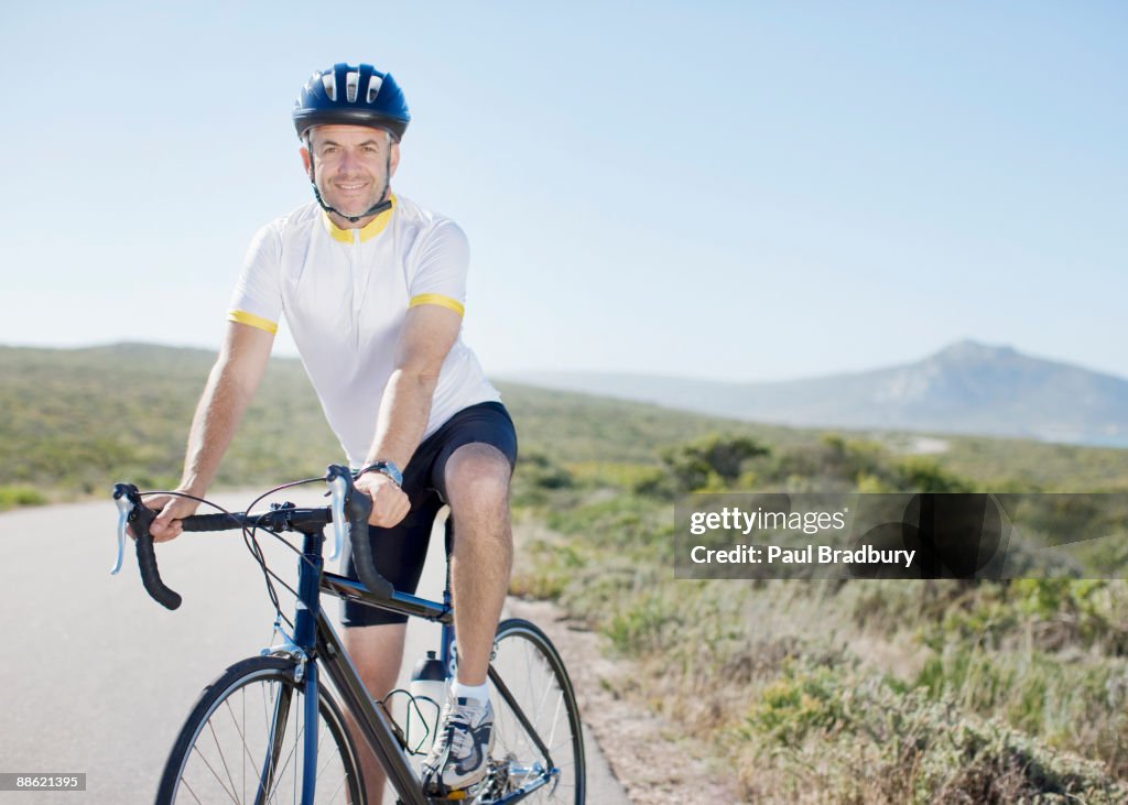 Man in helmet sitting on bicycle