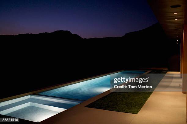 exterior of modern house and swimming pool at night - swimming pool night stock pictures, royalty-free photos & images