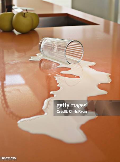 close up of milk spilled on counter - milk glass stock pictures, royalty-free photos & images