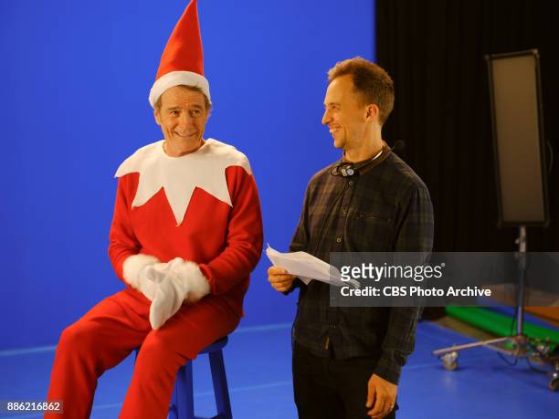 Bryan Cranston receives notes from producer James Longman during a sketch called Elf On A Shelf during "The Late Late Show with James Corden,"...