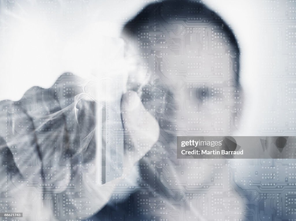Man holding credit card with microchip in foreground