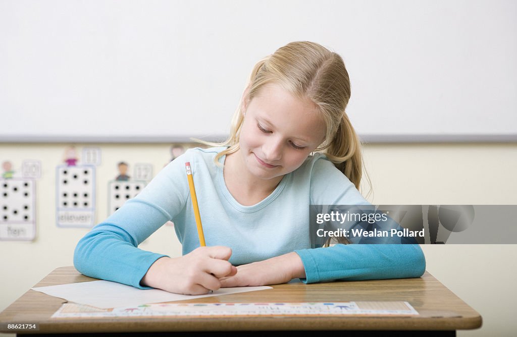 Girl taking test in classroom