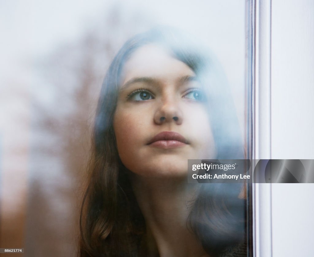 Girl looking out window