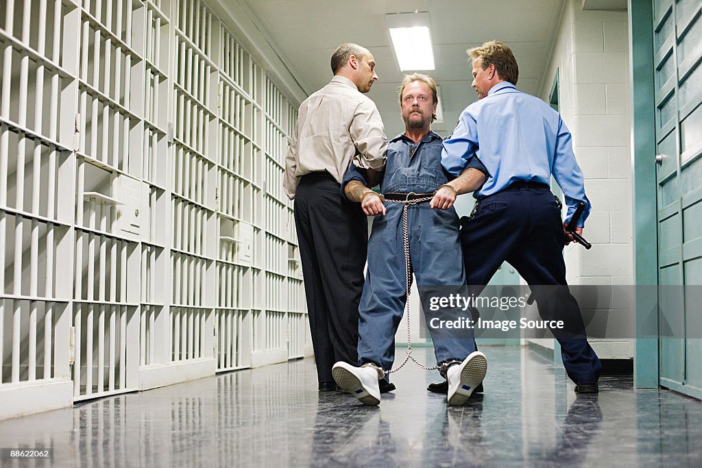 Prisoner being dragged down corridor