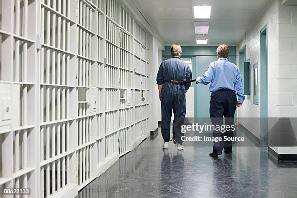 prisoner and guard - prison cell stock pictures, royalty-free photos & images