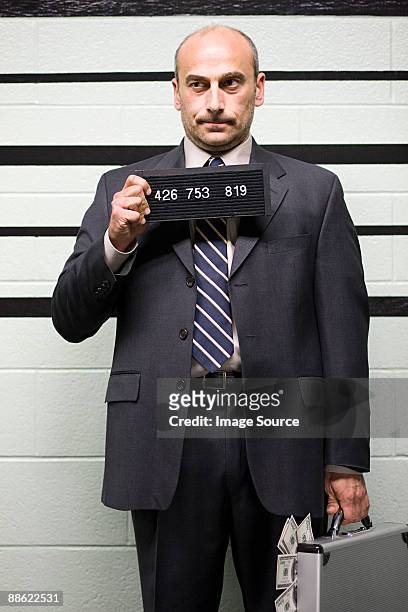 mugshot of businessman - verbrecherfoto stock-fotos und bilder