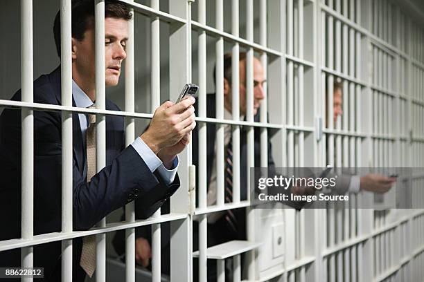 businessmen in jail - prisoner phone stock pictures, royalty-free photos & images