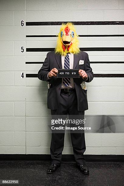 mugshot of businessman with chicken head - police line up stock-fotos und bilder
