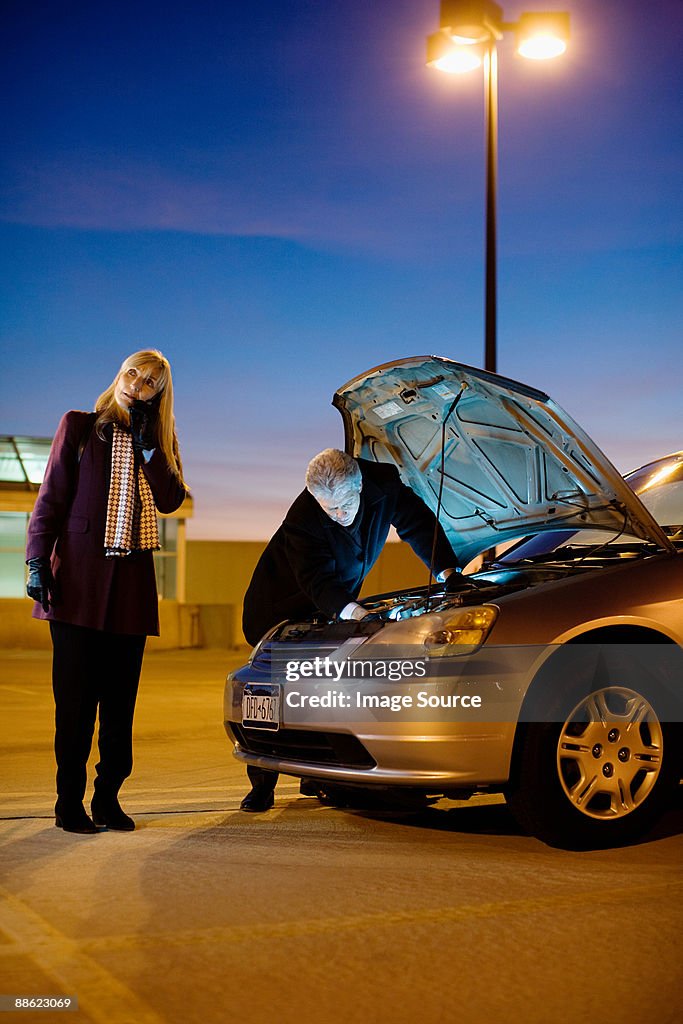 Couple with broken down car