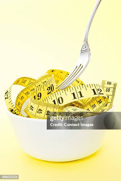 a tape measure in a bowl - tape measure stock pictures, royalty-free photos & images