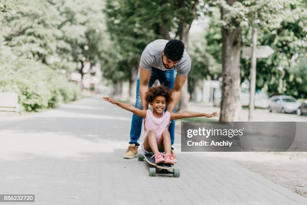 faster daddy, faster! - father longboard stock pictures, royalty-free photos & images