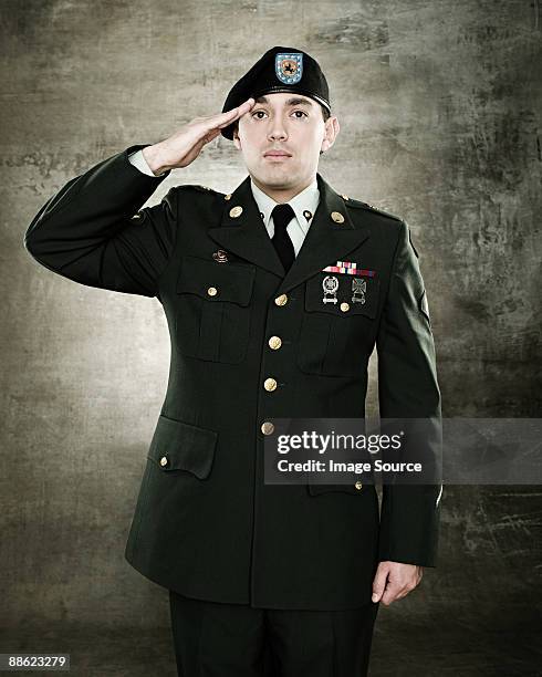 portrait of a soldier saluting - saluting soldiers stock pictures, royalty-free photos & images