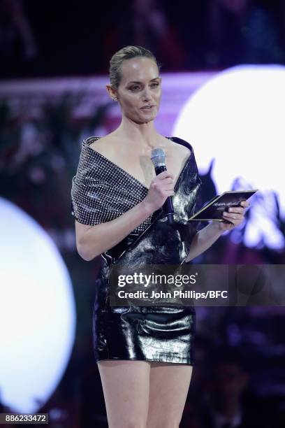 Amber Valletta presents the Accessories Designer of the Year award on stage during The Fashion Awards 2017 in partnership with Swarovski at Royal...