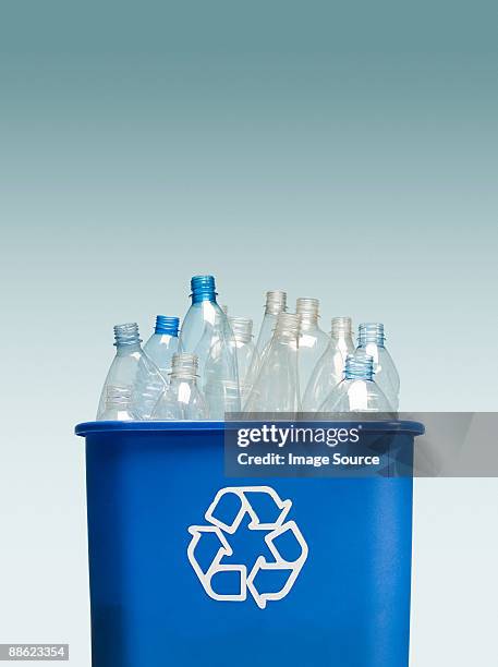 plastic bottles in a recycling bin - recycling bins stock pictures, royalty-free photos & images