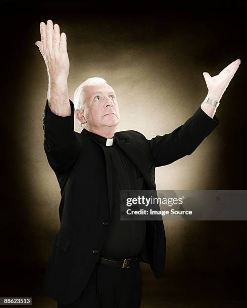 priest with his arms raised - priest collar stock pictures, royalty-free photos & images